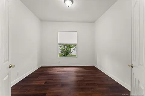 a view of kitchen with cabinets and window