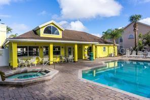 2751 North Poinciana Boulevard, Unit 27 Kissimmee, FL 34746 - Photo 17 of 18 a front view of a house with swimming pool and furniture