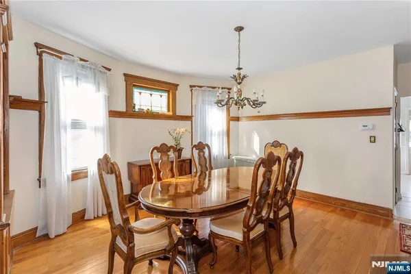 a view of a dining room with furniture and chandelier