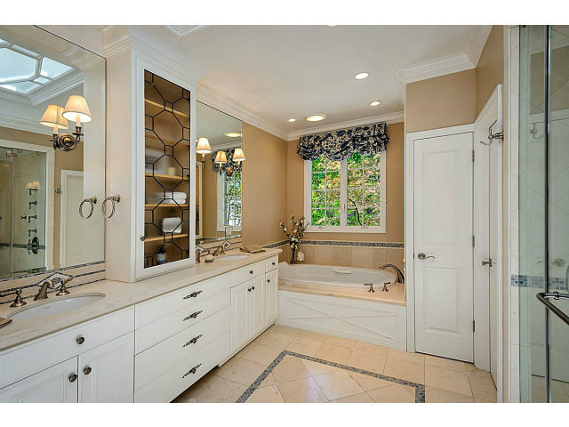 500 Pullman Road Hillsborough, CA 94010 - Photo 8 of 20 a bathroom with a tub a sink and a large mirror