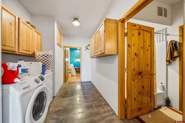 a view of a hallway with washer and dryer