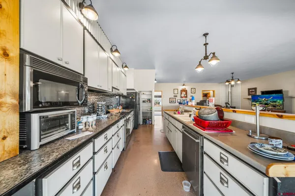 a kitchen with lots of counter top space and stainless steel appliances
