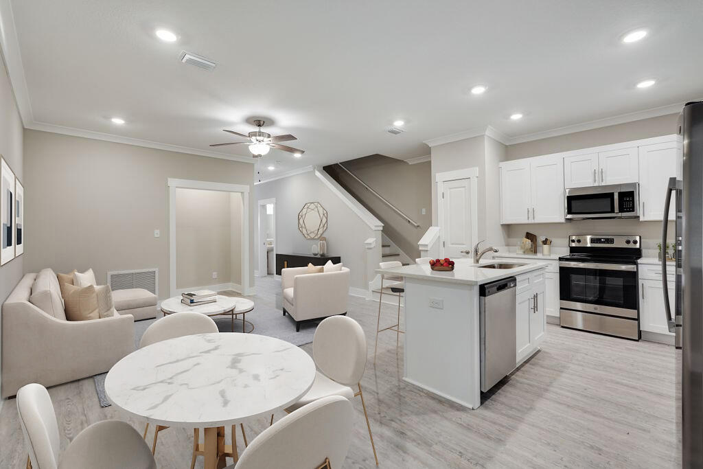 91 Date Palm Lane Freeport, FL 32439 - Photo 1 of 17 a kitchen with a sink stainless steel appliances and white cabinets