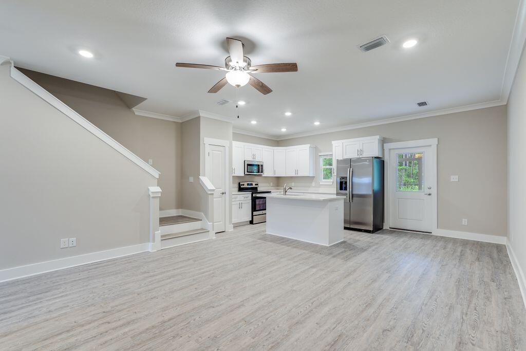 91 Date Palm Lane Freeport, FL 32439 - Photo 3 of 17 a view of kitchen with cabinets microwave and stove
