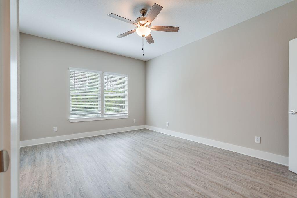 91 Date Palm Lane Freeport, FL 32439 - Photo 9 of 17 wooden floor in an empty room with a window