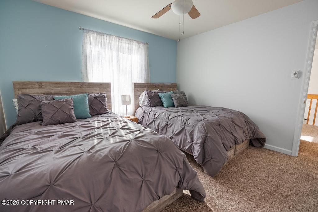 366 Appleseed Road Pocono Pines, PA 18350 - Photo 23 of 32 a bedroom with two beds and a chandelier