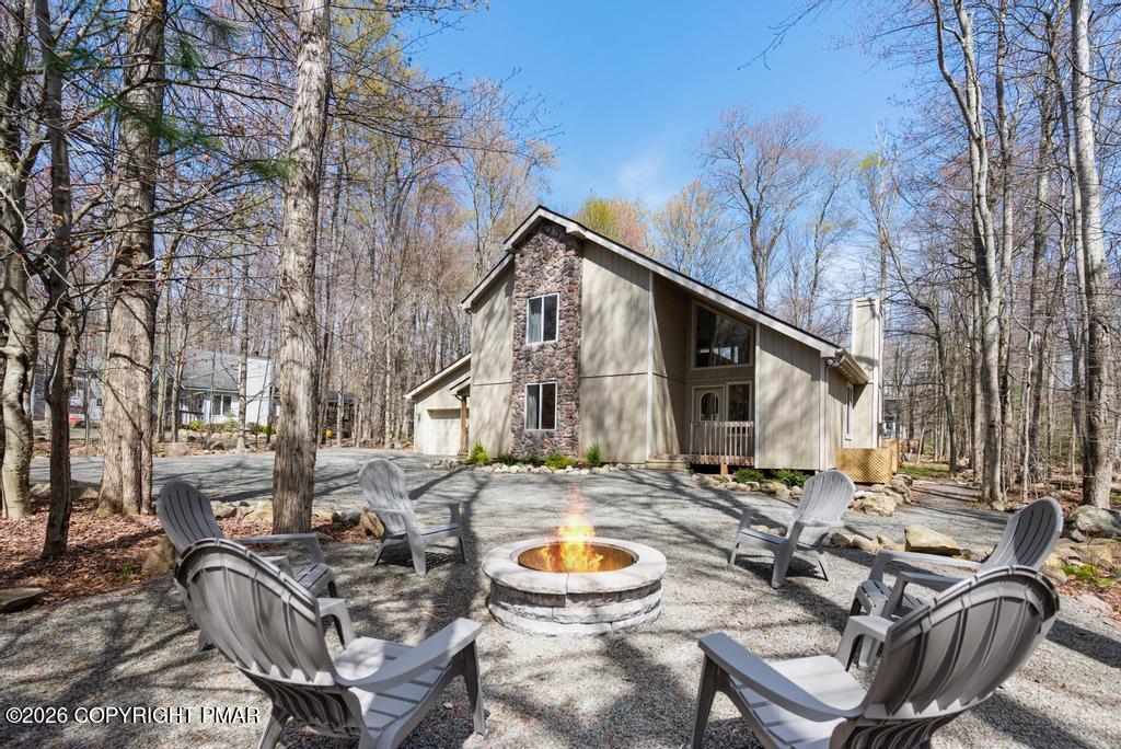366 Appleseed Road Pocono Pines, PA 18350 - Photo 29 of 32 a backyard of a house with fire pit and outdoor seating