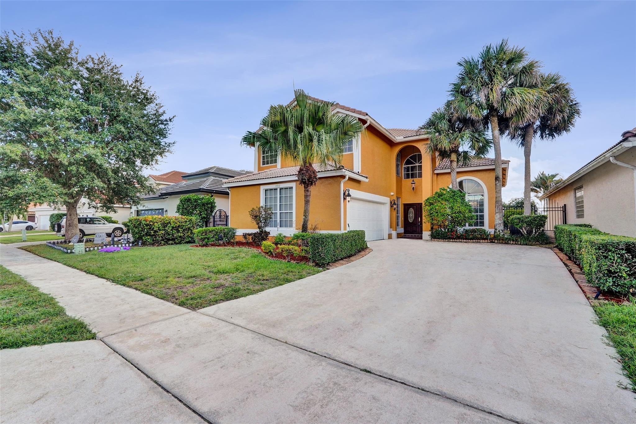 10902 Tamoron Lane Boca Raton, FL 33498 - Photo 1 of 66 front view of a house with a yard