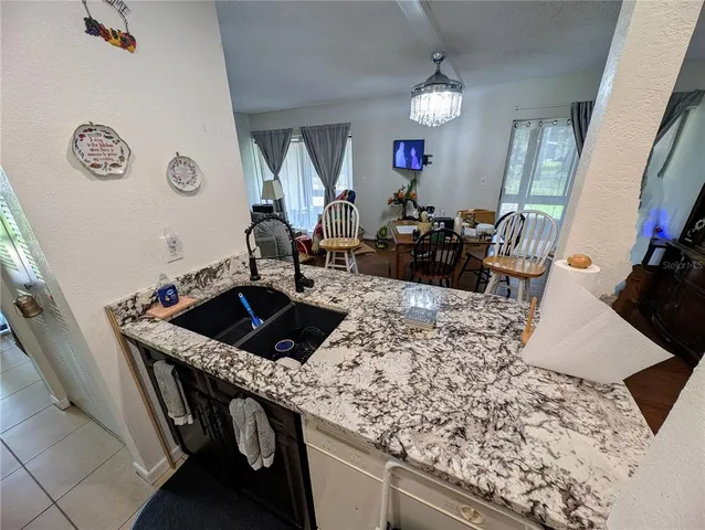 a living room with granite countertop furniture and a fireplace