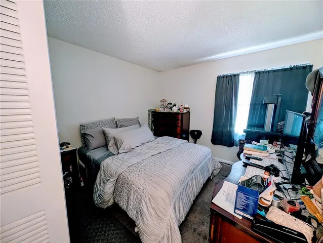 a bed room with a bed and a window