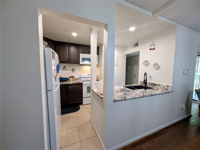 a large kitchen with a stove and a refrigerator
