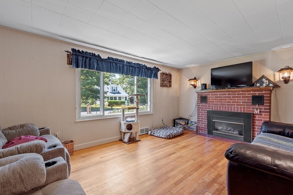 701 Silver Lake Street Athol, MA 01331 - Photo 11 of 34 a living room with furniture a flat screen tv and a fireplace