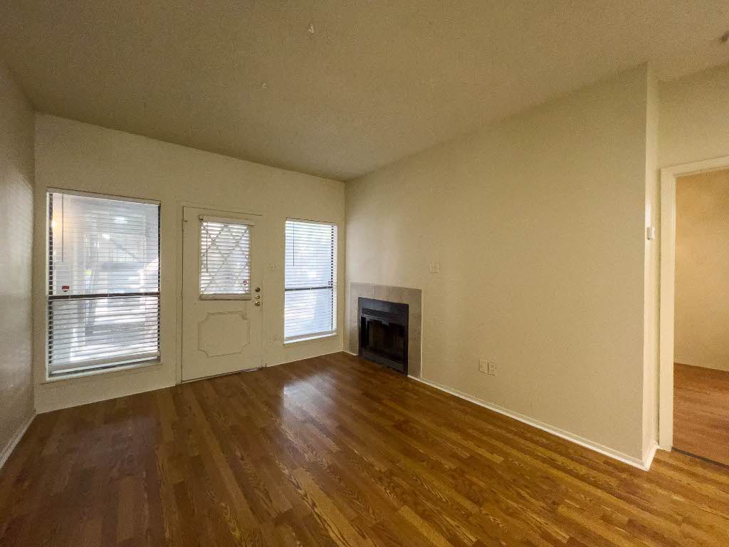 806 West 24th Street, Unit 130 Austin, TX 78705 - Photo 3 of 8 an empty room with wooden floor and windows