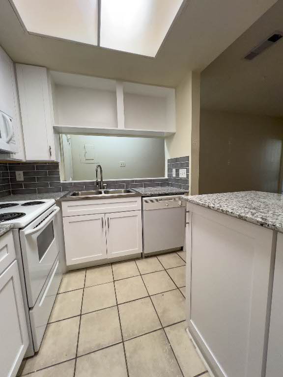 806 West 24th Street, Unit 130 Austin, TX 78705 - Photo 5 of 8 a kitchen with a stove sink and cabinets