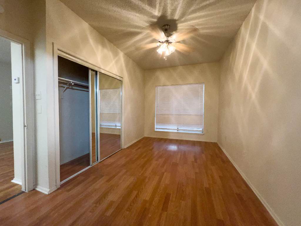 806 West 24th Street, Unit 130 Austin, TX 78705 - Photo 7 of 8 wooden floor in an empty room with a window