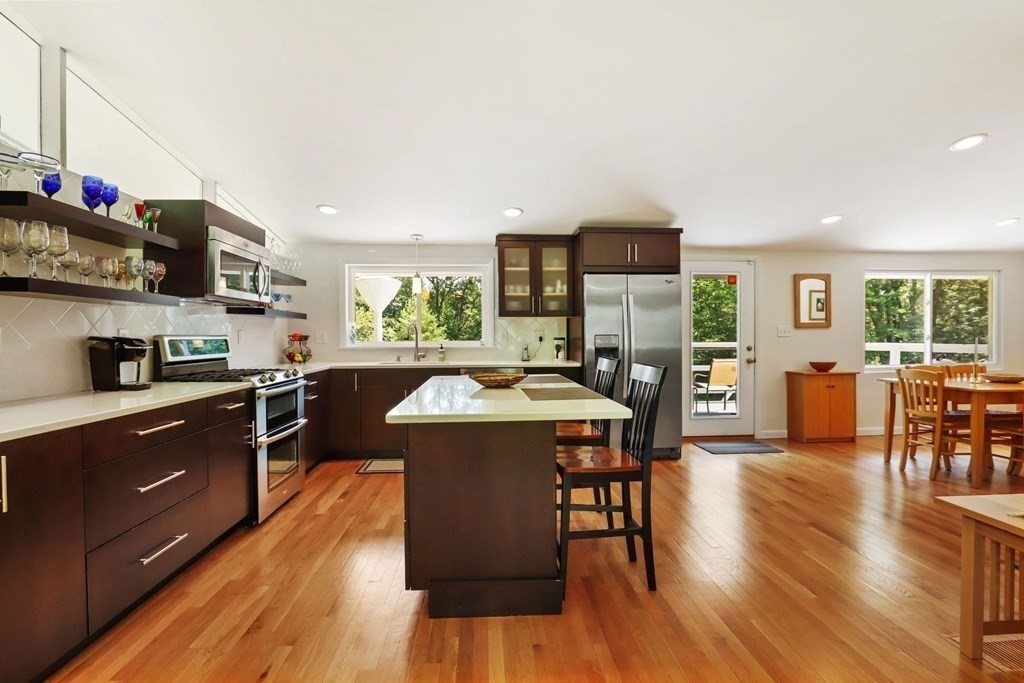 430 Heald Road Carlisle, MA 01741 - Photo 17 of 42 a kitchen with stainless steel appliances granite countertop wooden floors and view living room