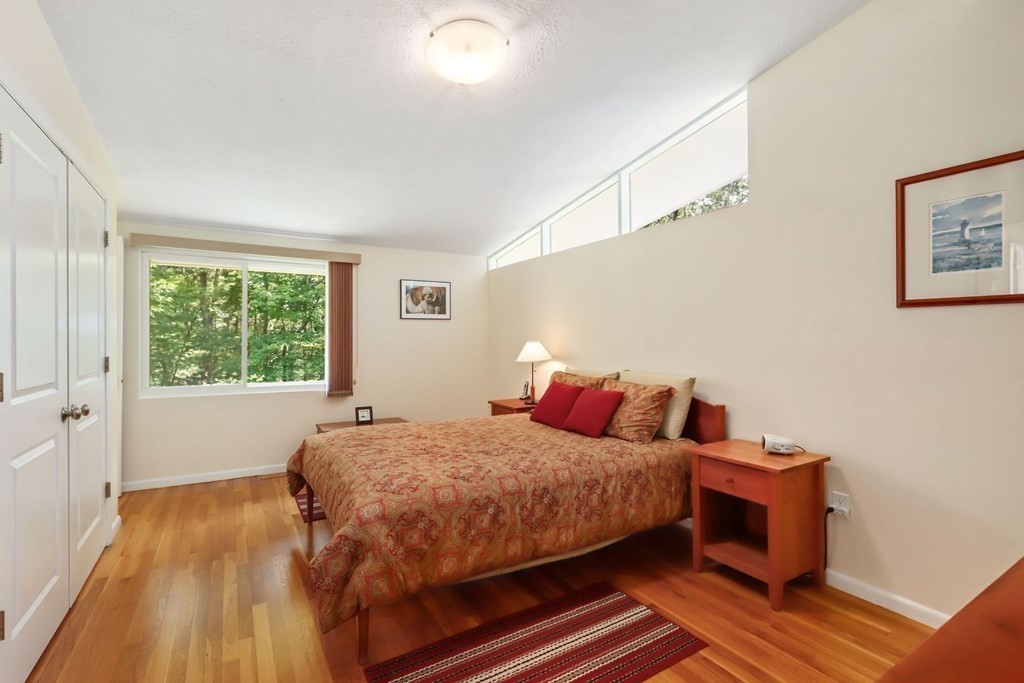 430 Heald Road Carlisle, MA 01741 - Photo 22 of 42 a bedroom with a bed and wooden floor