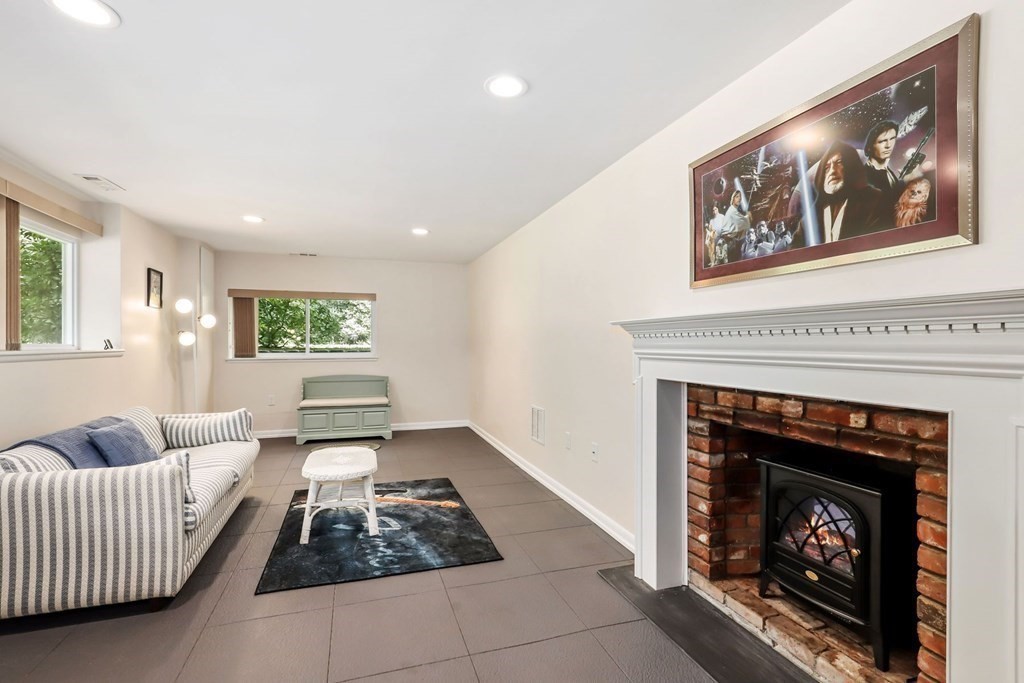 430 Heald Road Carlisle, MA 01741 - Photo 28 of 42 a living room with furniture and a fireplace