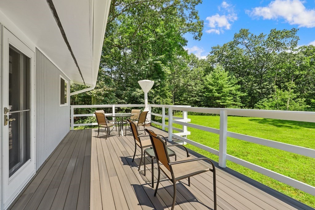 430 Heald Road Carlisle, MA 01741 - Photo 34 of 42 a view of a chairs and table on the wooden deck