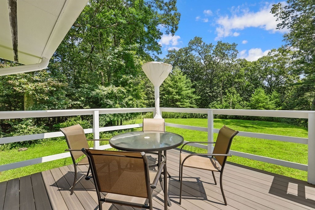 430 Heald Road Carlisle, MA 01741 - Photo 35 of 42 a view of a chair and table on the deck