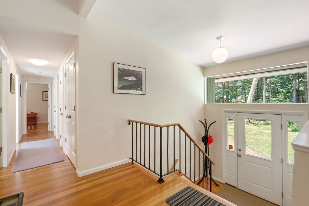 430 Heald Road Carlisle, MA 01741 - Photo 4 of 42 a view of a hallway with wooden floor and windows
