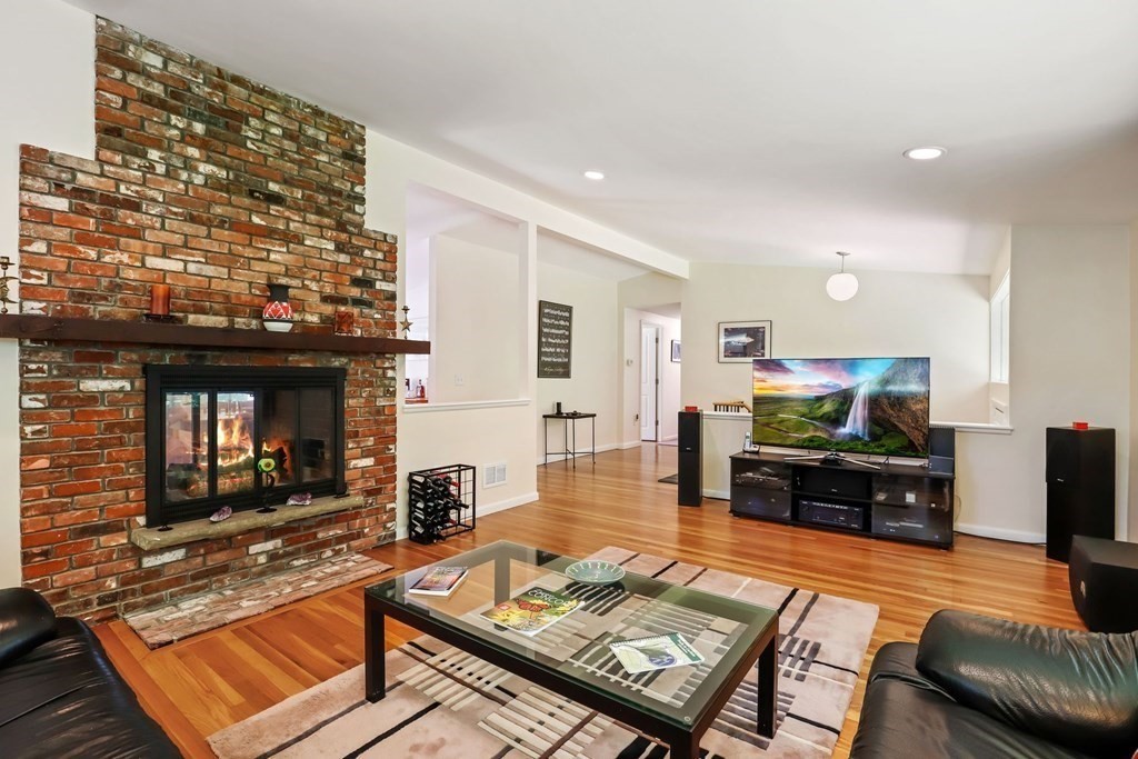 430 Heald Road Carlisle, MA 01741 - Photo 6 of 42 a living room with furniture a flat screen tv and a fireplace