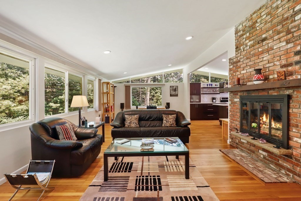 430 Heald Road Carlisle, MA 01741 - Photo 8 of 42 a living room with furniture a fireplace and a large window
