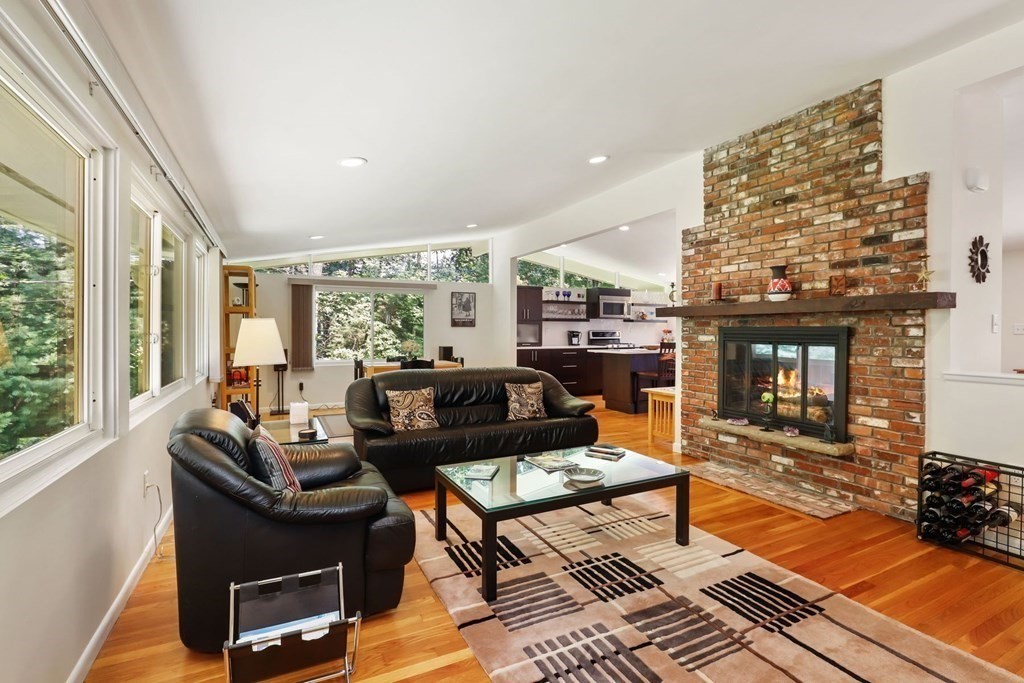 430 Heald Road Carlisle, MA 01741 - Photo 9 of 42 a living room with furniture a rug and a floor to ceiling window