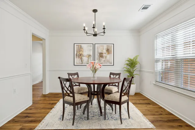 a view of a dining room with furniture window and wooden floor