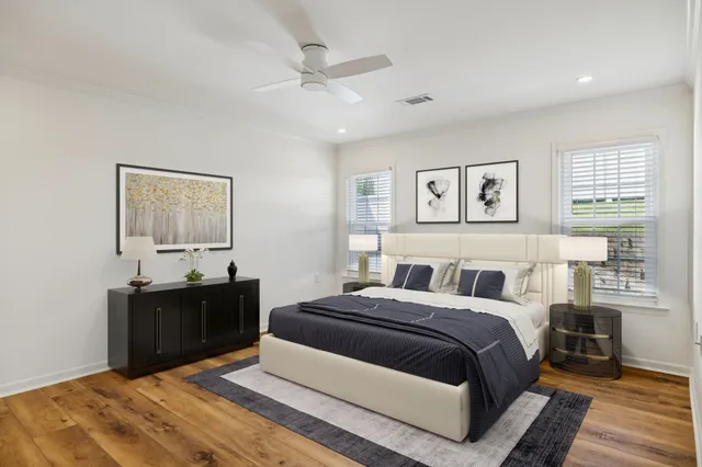 a bedroom with a large bed and a chandelier