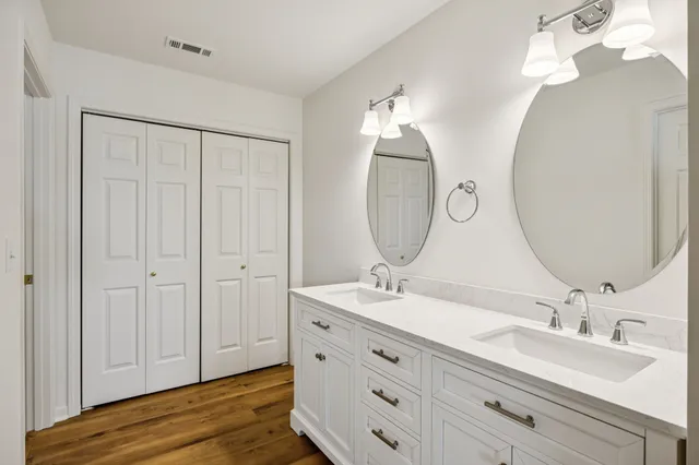 a bathroom with a double vanity sink and a mirror