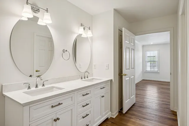 a bathroom with a double vanity sink and a mirror
