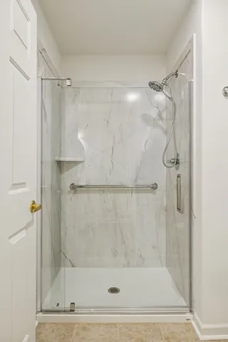 a bathroom with a shower and a glass door shower