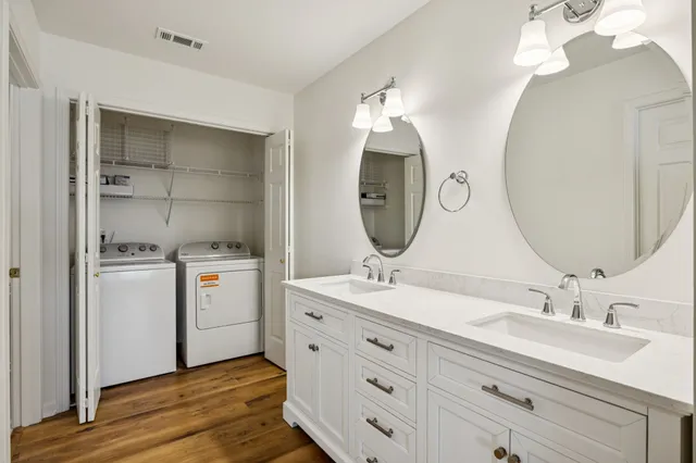 a bathroom with a double vanity sink and a mirror