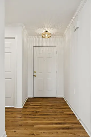 a view of a livingroom with wooden floor and a ceiling fan