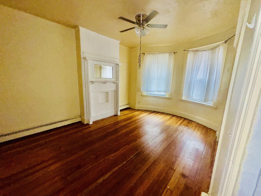 20 South Huntington Avenue, Unit 1 Boston, MA 02130 - Photo 5 of 9 a view of empty room with wooden floor and fan