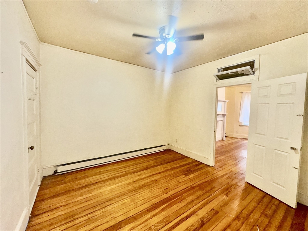 20 South Huntington Avenue, Unit 1 Boston, MA 02130 - Photo 7 of 9 wooden floor in an empty room with a window