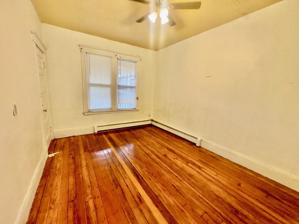 20 South Huntington Avenue, Unit 1 Boston, MA 02130 - Photo 8 of 9 a view of an empty room with a window and wooden floor