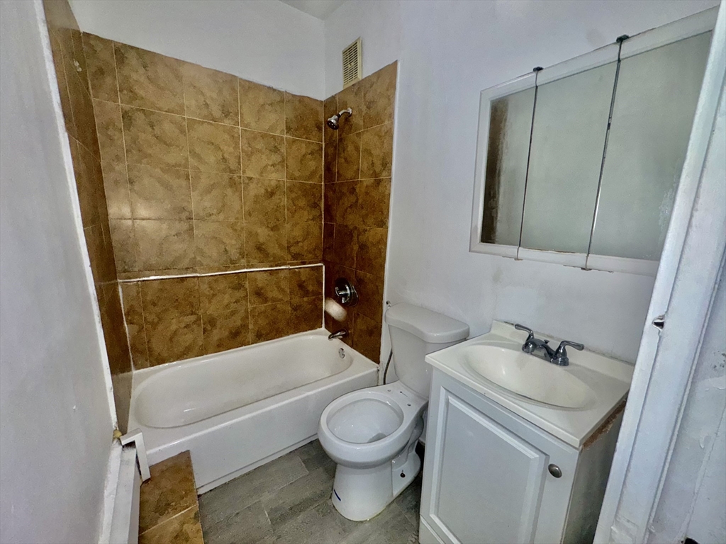 20 South Huntington Avenue, Unit 1 Boston, MA 02130 - Photo 9 of 9 a bathroom with a sink a toilet and shower