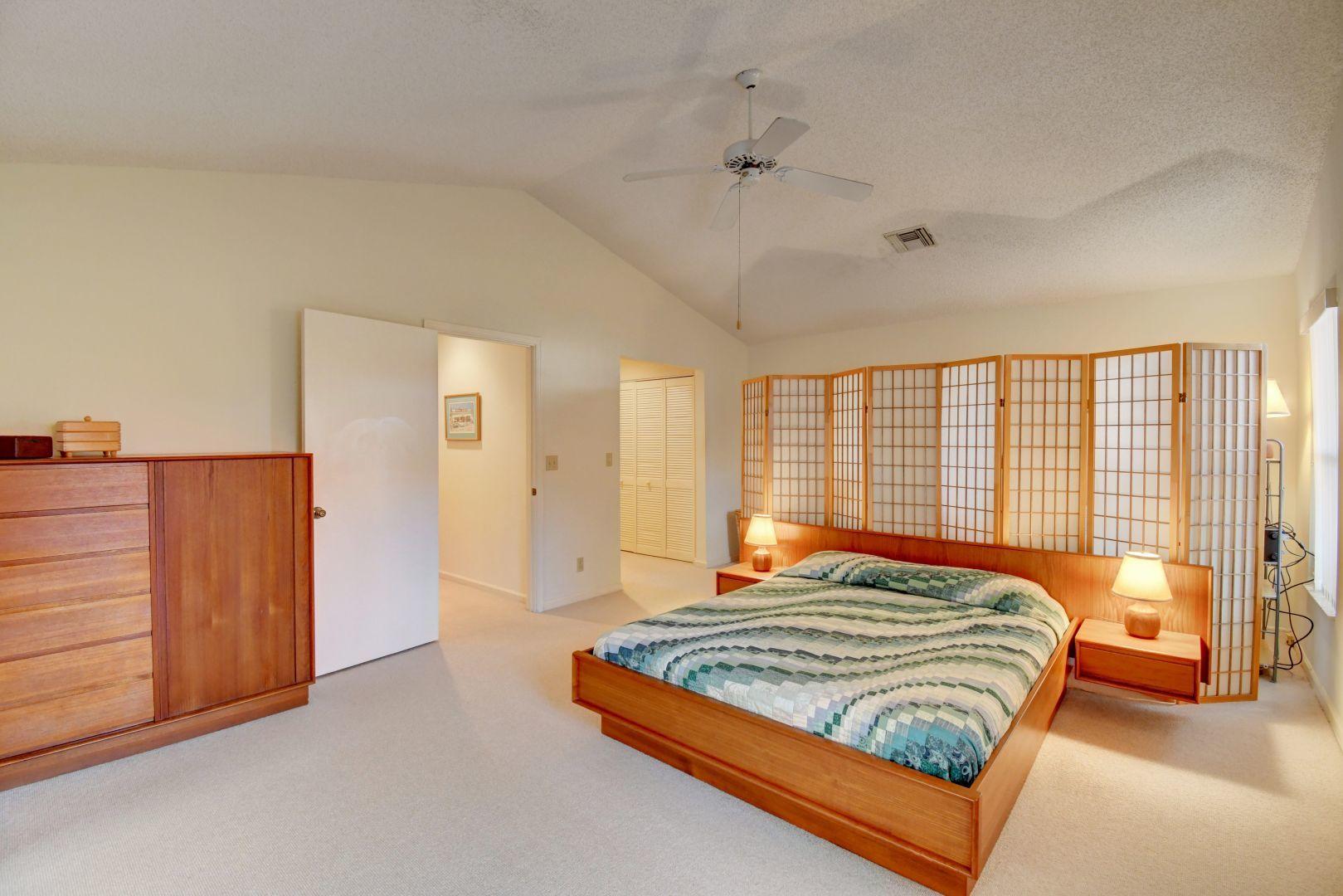 23383 Water Circle Boca Raton, FL 33486 - Photo 8 of 35 a bedroom with a bed and wooden floor