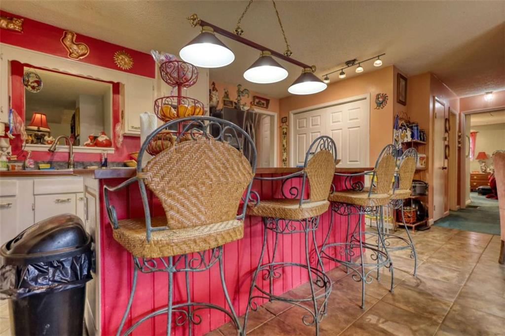 279 Spring Street Winder, GA 30680 - Photo 11 of 43 a view of a kitchen area with furniture and chandelier