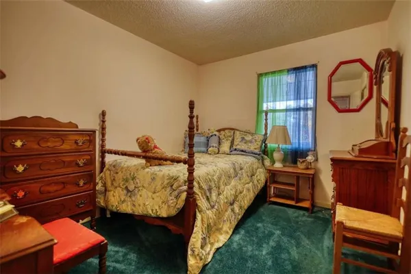 a bed room with a bed and a desk