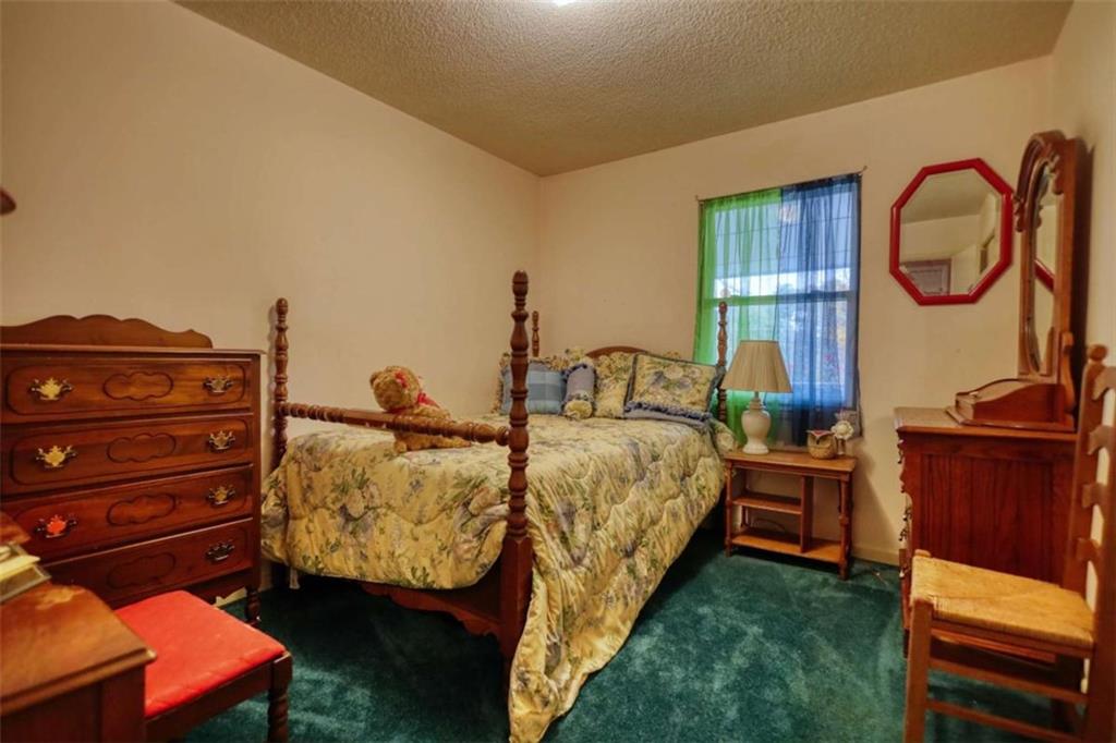 279 Spring Street Winder, GA 30680 - Photo 17 of 43 a bed room with a bed and a dresser