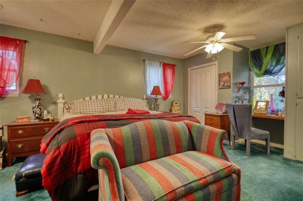 279 Spring Street Winder, GA 30680 - Photo 23 of 43 a bedroom with a bed and a chandelier