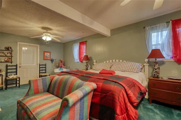 a bedroom with a bed and window