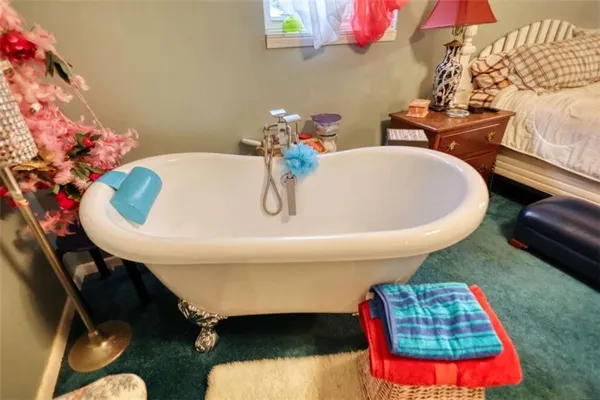 a bedroom with a bed and a mirror