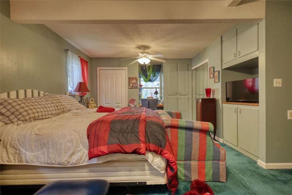 279 Spring Street Winder, GA 30680 - Photo 27 of 43 a bedroom with a bed and a mirror