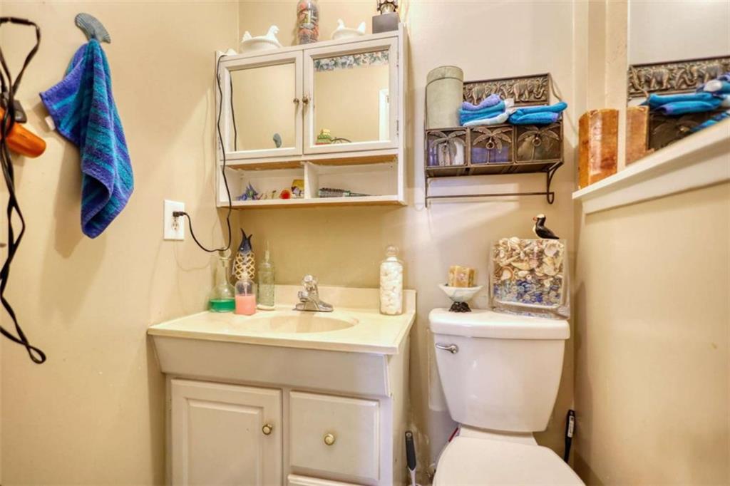 279 Spring Street Winder, GA 30680 - Photo 28 of 43 a bathroom with a toilet sink and mirror