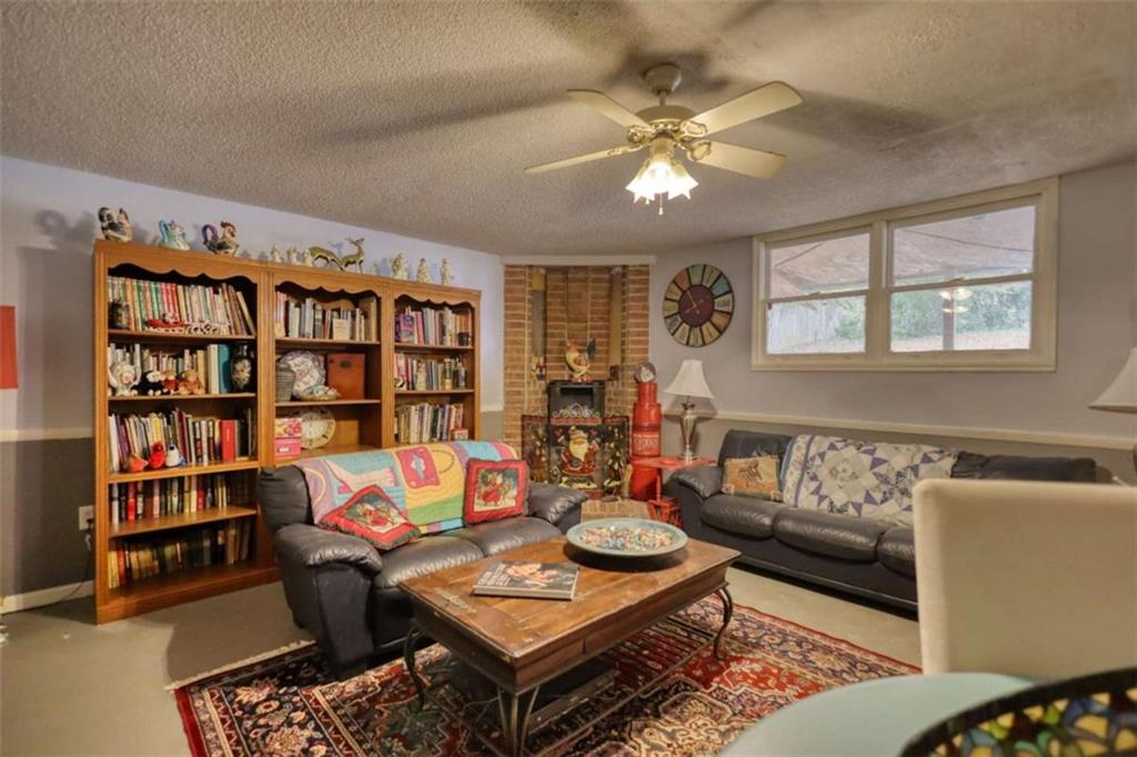 279 Spring Street Winder, GA 30680 - Photo 30 of 43 a living room with furniture a bookshelf and a window
