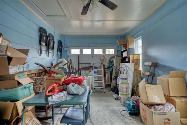 a bedroom with furniture and a large window